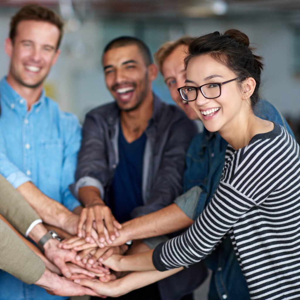 Hands together in teamwork celebration.